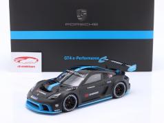 Porsche 718 Cayman GT4 e-Performance 2022 negro / azul 1:18 Spark